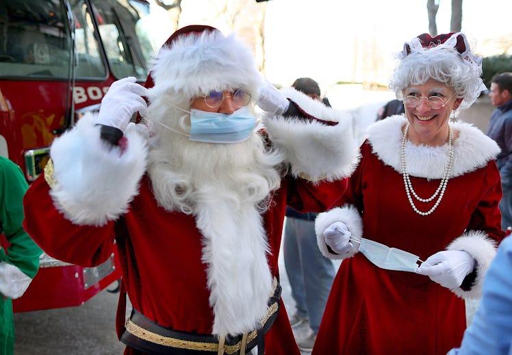 Boston, MA - December 13: Santa Claus and Mrs. Claus put put on face masks after they rode on a Bost...