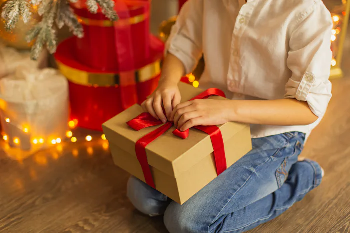 Child holding Christmas gift box.