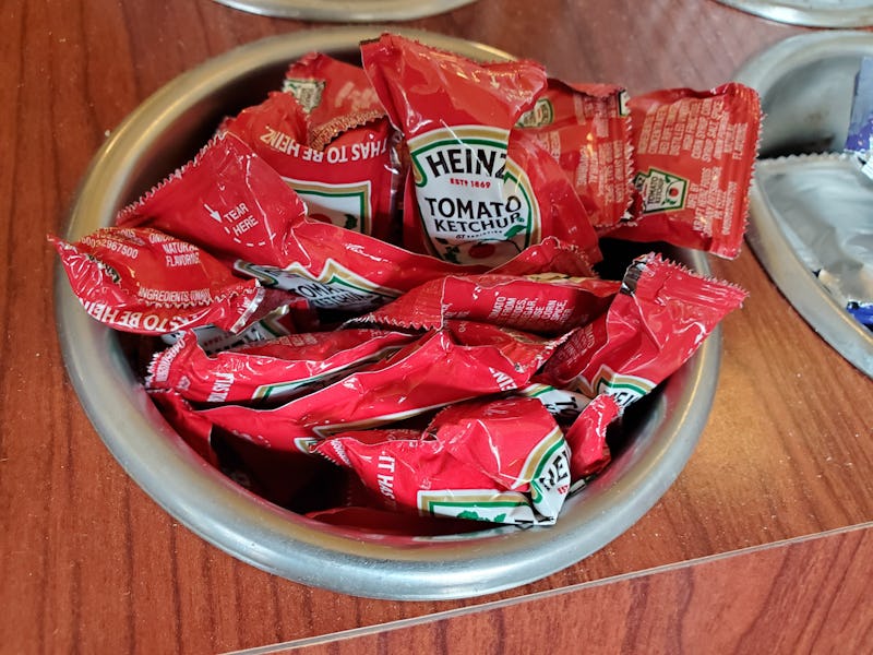 Close-up of container of Heinz brand ketchup packets in restaurant setting, Lafayette, California, N...