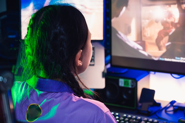 A teenager gaming on a desktop.