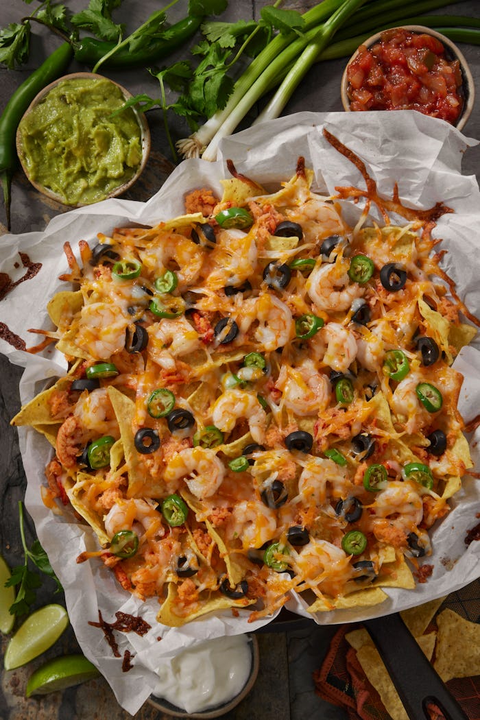 Shrimp and Lobster Nachos with Jalapenos, Salsa, Sour Cream, Guacamole, Black Olives, Tomatoes and G...