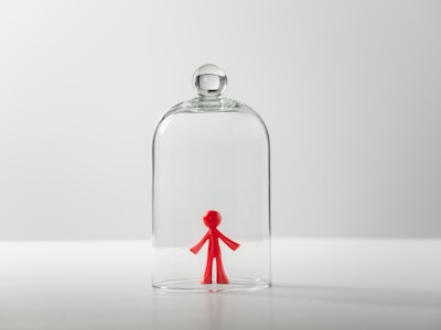 Plastic figure of a man under a glass cover - loneliness, depression, isolation concept