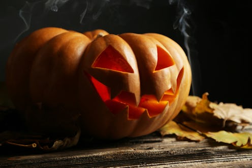 Halloween pumpkin on brown wooden background