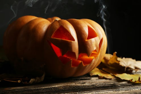 Halloween pumpkin on brown wooden background