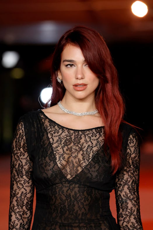 Dua Lipa wears a lace dress and black thong to attend the 3rd Annual Academy Museum Gala. 