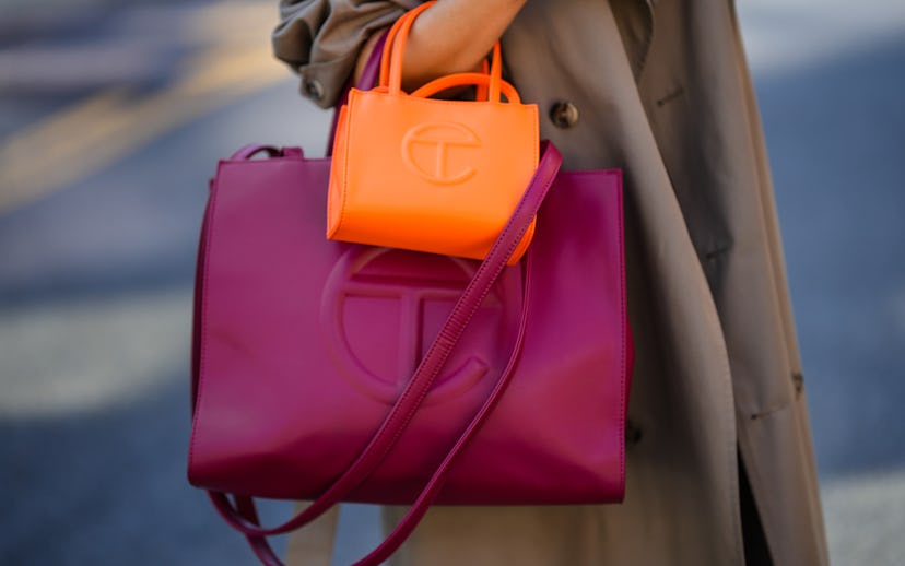 NEW YORK, NEW YORK - SEPTEMBER 14: Samia Laaboudi wears a beige long trench coat, a neon orange shin...