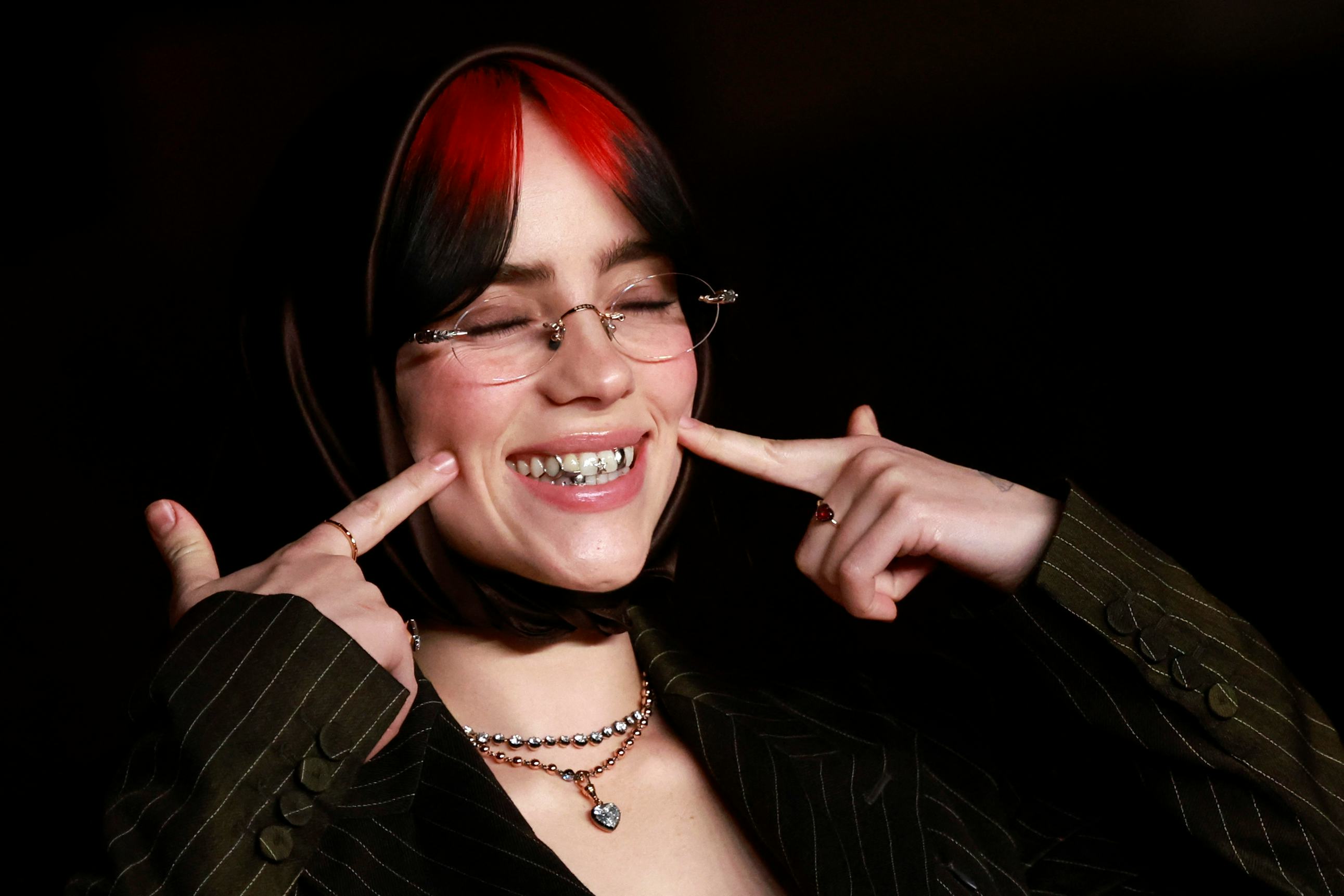 Billie Eilish wore a plunging low-cut matching pinstripe set with a headscarf &amp; silver tooth gems at&hellip;