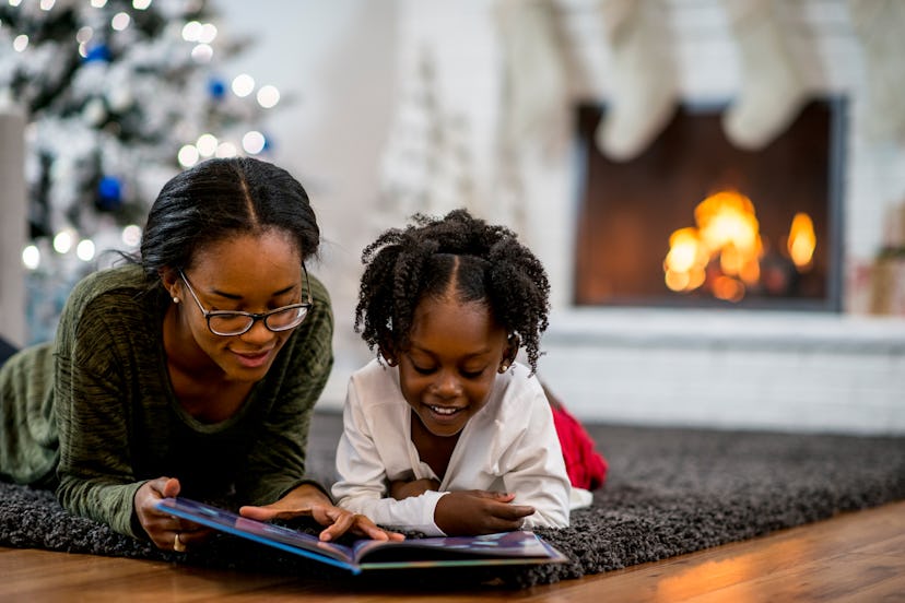 A mother and daughter reading Christmas story, in a story about how to prepare your kids to meet San...