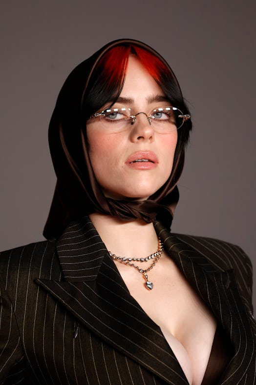 Billie Eilish wore a plunging low-cut pinstripe blazer & maxi skirt co-ord set with a matching heads…