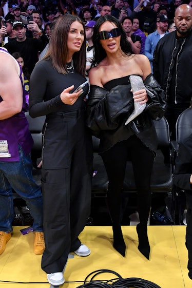 Kim Kardashian (R) attends a basketball game between the Los Angeles Lakers and the Phoenix Suns at ...