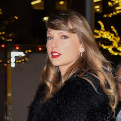 On Dec. 6, 2023, Taylor Swift attended the premiere of "Poor Things," pairing her red lips and pedic...