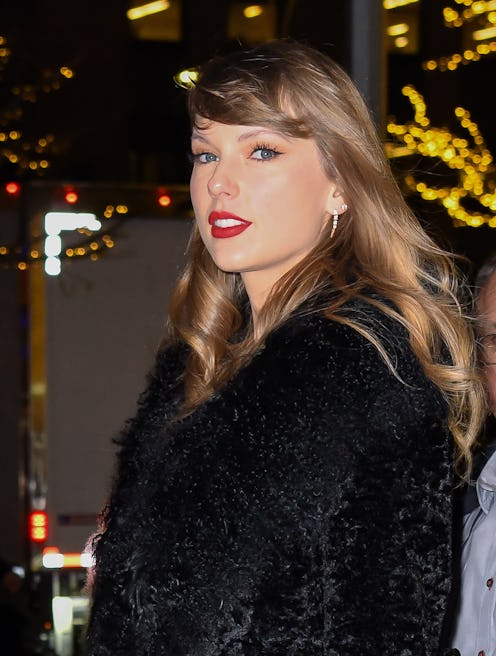 On Dec. 6, 2023, Taylor Swift attended the premiere of "Poor Things," pairing her red lips and pedic...