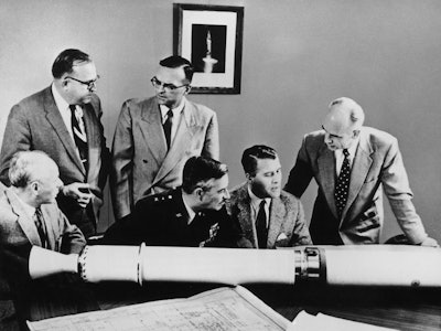 Key project officers at the Army Ballistic Missile Agency in Redstone Arsenal, Alabama, examine a pr...