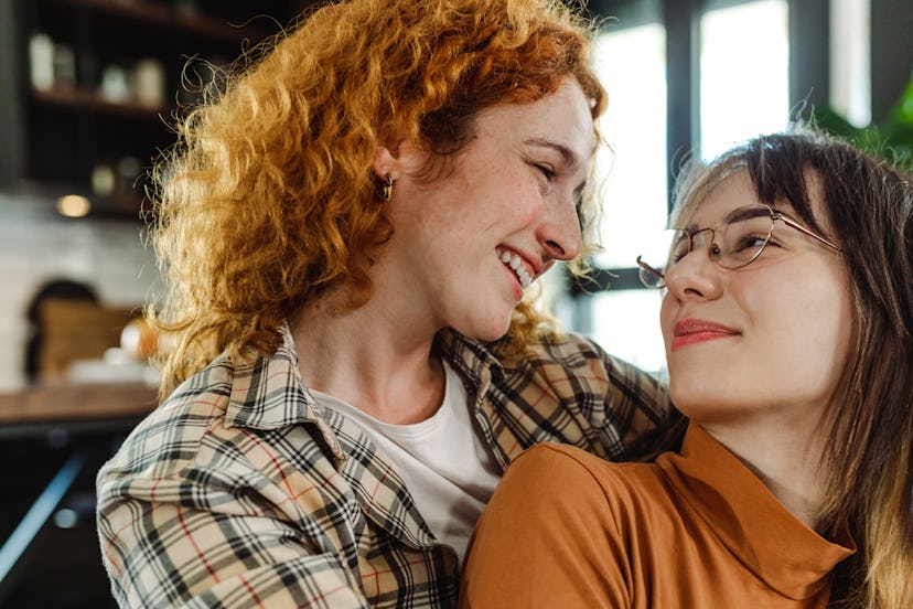 Shot of a young lesbian couple at home embracing and having romantic moments. Young people in emotio...