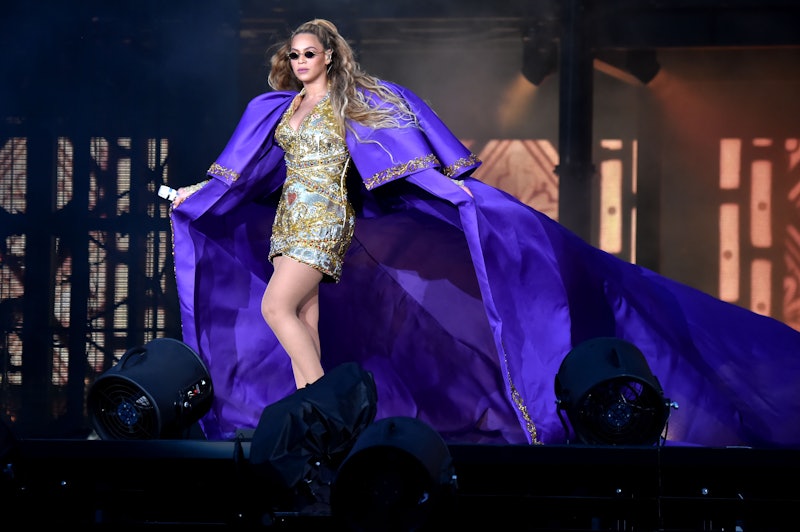 Beyonce performs in purple on stage during the "On the Run II" Tour 
