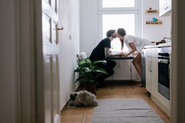 Young couple sitting in kitchen having a romantic moment in an article about sexual compatibility 