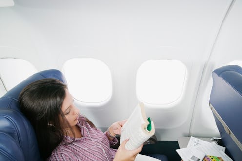 woman reading on a plane