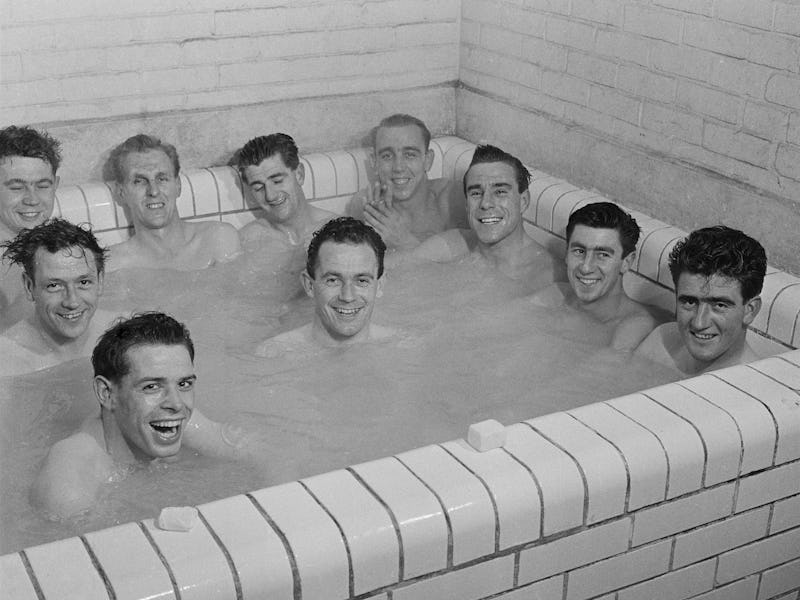 King's Lynn FC football players taking a bath after training, UK, 1960. Not in order: McKay, Baxter,...