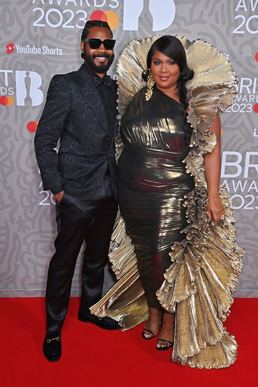 LONDON, ENGLAND - FEBRUARY 11: (EDITORIAL USE ONLY) Myke Wright and Lizzo arrive at The BRIT Awards ...