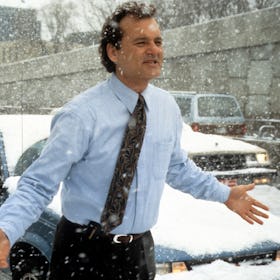 Bill Murray runs through the snow in a scene from the film 'Groundhog Day', 1993. (Photo by Columbia...