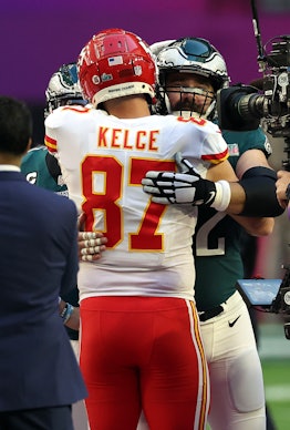 GLENDALE, ARIZONA - FEBRUARY 12: Travis Kelce #87 of the Kansas City Chiefs hugs Jason Kelce #62 of ...