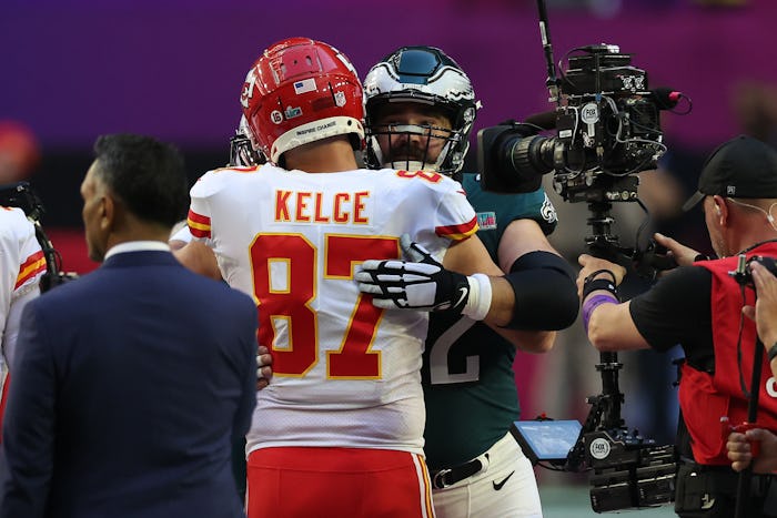 GLENDALE, ARIZONA - FEBRUARY 12: Travis Kelce #87 of the Kansas City Chiefs hugs Jason Kelce #62 of ...
