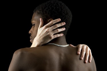 woman caressing man's back