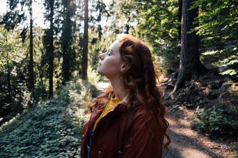 Young woman with red hair enjoying time in nature in south of Germany. Part of a series with video