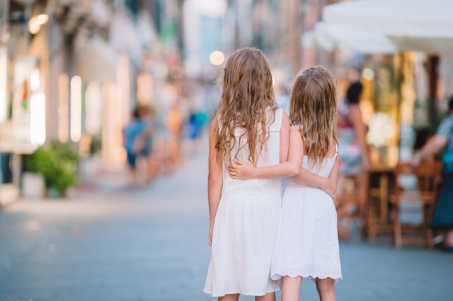Adorable little girls in old city in Toscany on italian vacation, In a popular post on the “Am I The...