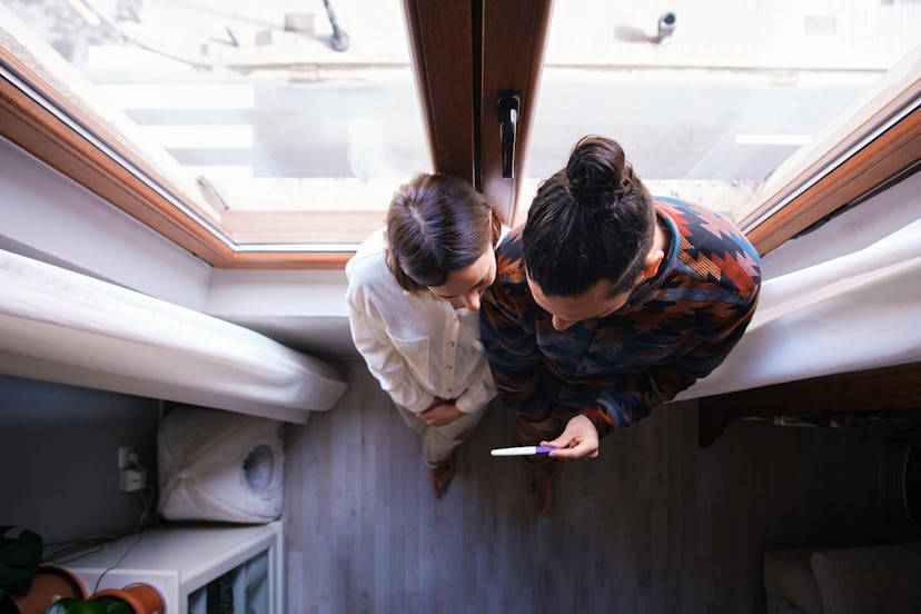 couple looking at fertility/pregnancy test in article about ozempic and fertility