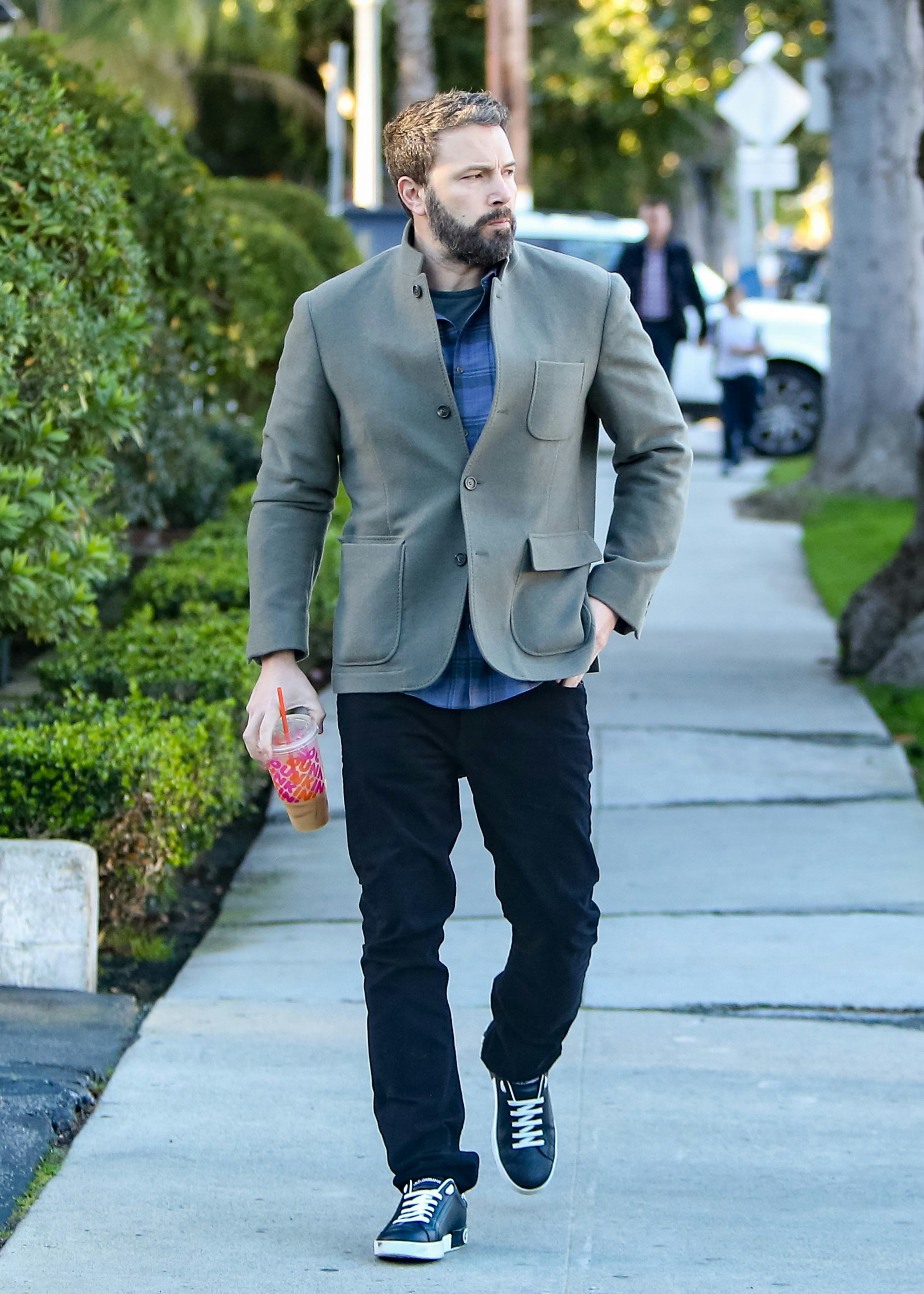 Ben Affleck drinks an iced coffee from Dunkin'.