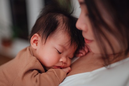 a mother holding a baby, an article about the 4 month sleep regression