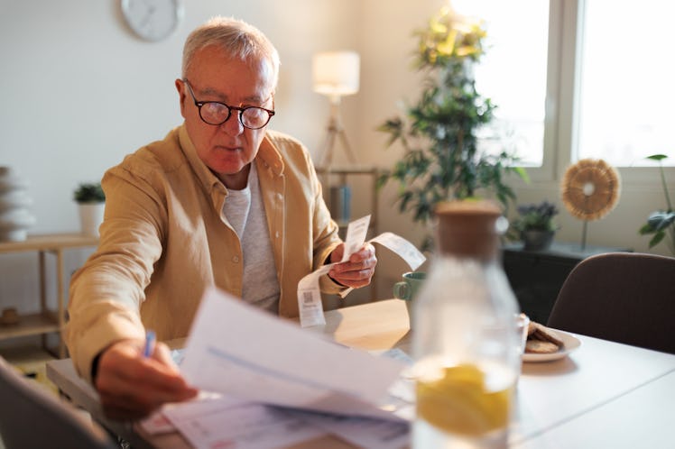 Shot of a senior man doing the household finances in his living room