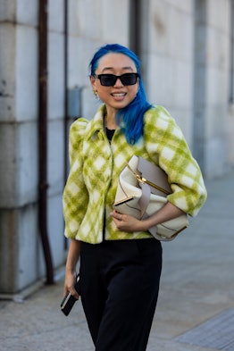 Margaret Zhang wears sunglasses, checkered green jacket, black pants, beige bag outside Gabriela Hea...