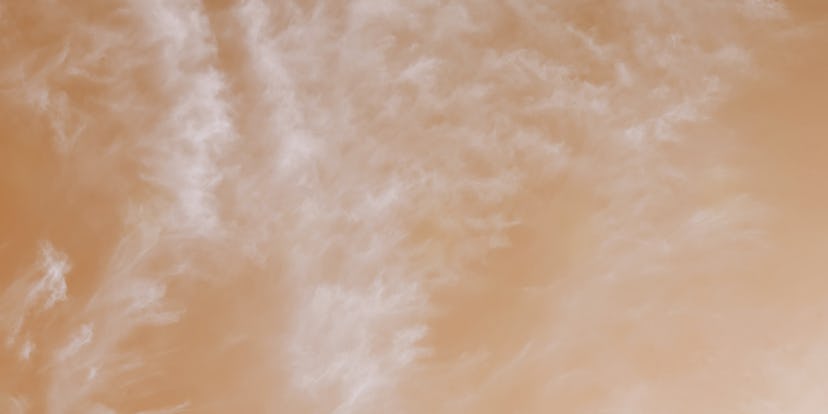 The warm color of a fairy-tale sky with light feathery clouds. Sky panorama processing.