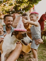 Photo of a young family with two kids being all cheerful and playful because they are celebrating th...