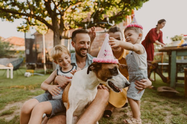 Photo of a young family with two kids being all cheerful and playful because they are celebrating th...