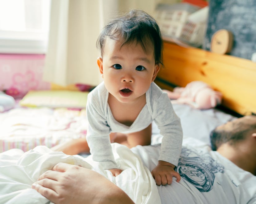 baby in bed in an article about 6 month sleep regression what causes it and how to get through