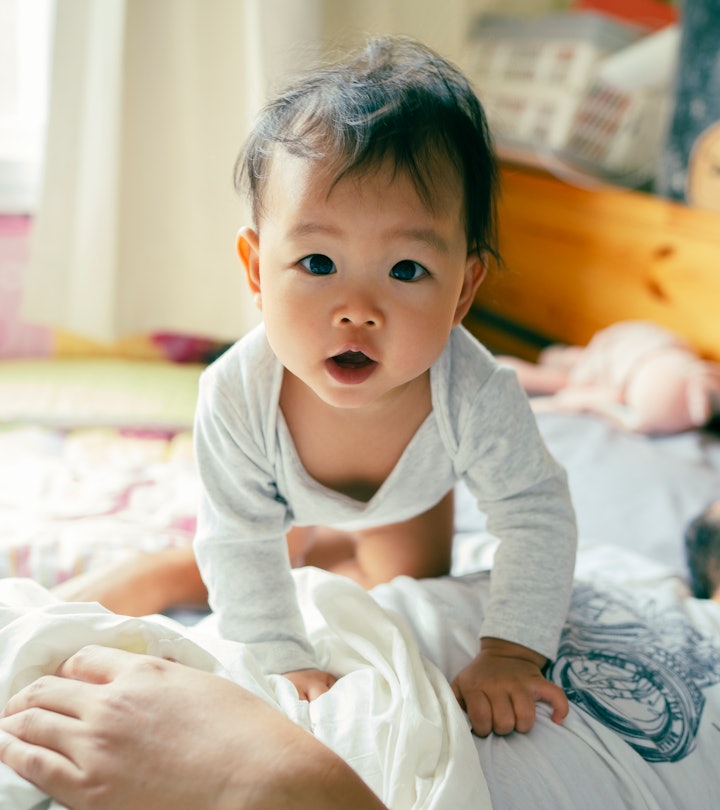 baby in bed in an article about 6 month sleep regression what causes it and how to get through