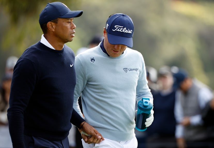 PACIFIC PALISADES, CALIFORNIA - FEBRUARY 16: Tiger Woods of the United States (L) and Justin Thomas …