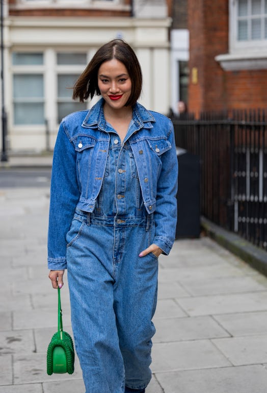 Tiffany Hsu wears denim jacket, vest, jeans, green  outside 16Arlington during London Fashion Week F...