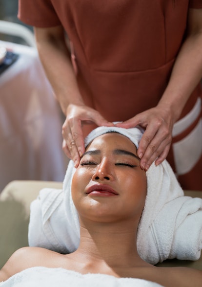 A woman getting a facial massage