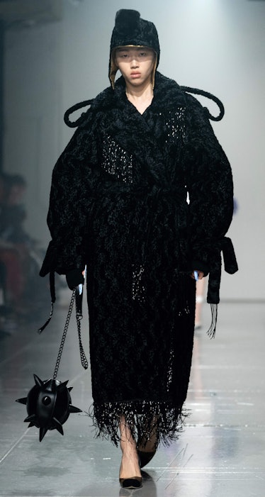 A model presents a creation for fashion brand Asai during the catwalk show for their Autumn/Winter 2...