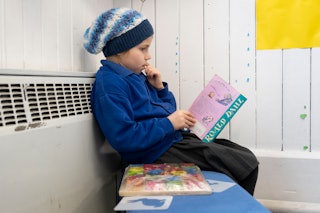 A child reads a Roald Dahl book at Roath Park Primary School on February 23, 2021 in Cardiff, Wales....