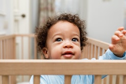 cute toddler in a crib in an article about the 18 month sleep regression