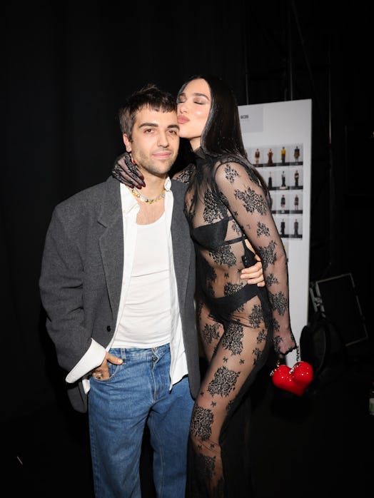 Giuliano Calza and Dua Lipa pose backstage at the GCDS fashion show during the Milan Fashion Week 