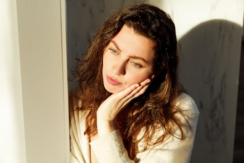 Portrait of young woman on sunny day with shade on her face brunette real person