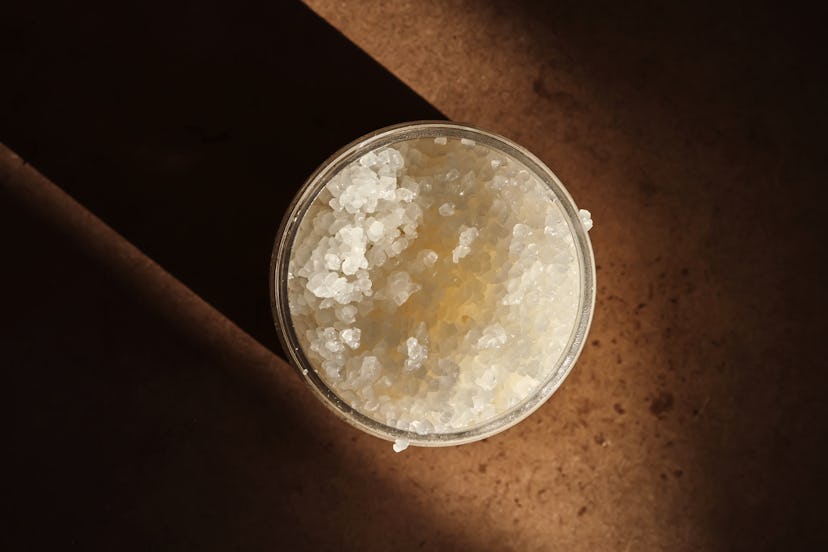 The texture of a freshly opened sugar scrub in a jar. Demonstration of a spa product in the lifestyl...