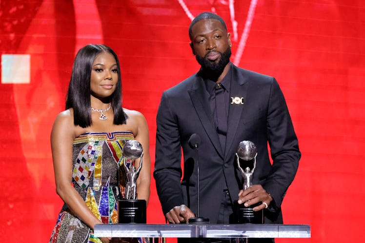 (L-R) Gabrielle Union and Dwyane Wade accept the President's Award onstage during the 54th NAACP Ima...