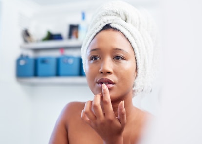 Morning skincare and black woman on mirror in bathroom check face for beauty. African american girl ...
